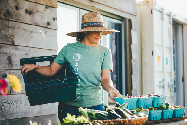 Lady in green shirt and hat at farmers market at Jordan Ranch in Fulshear, TX